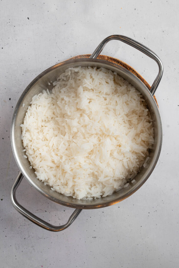 Fluffy cooked rice in a steel pot.