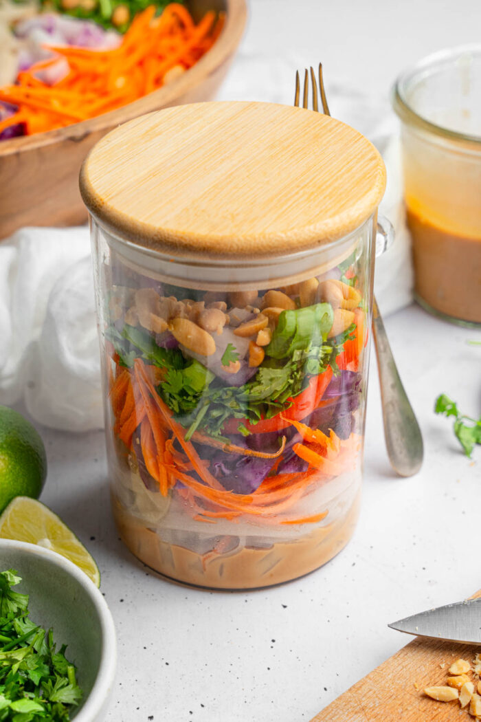 A jar with layered Thai noodle salad, meal prepped for the rest of the week.