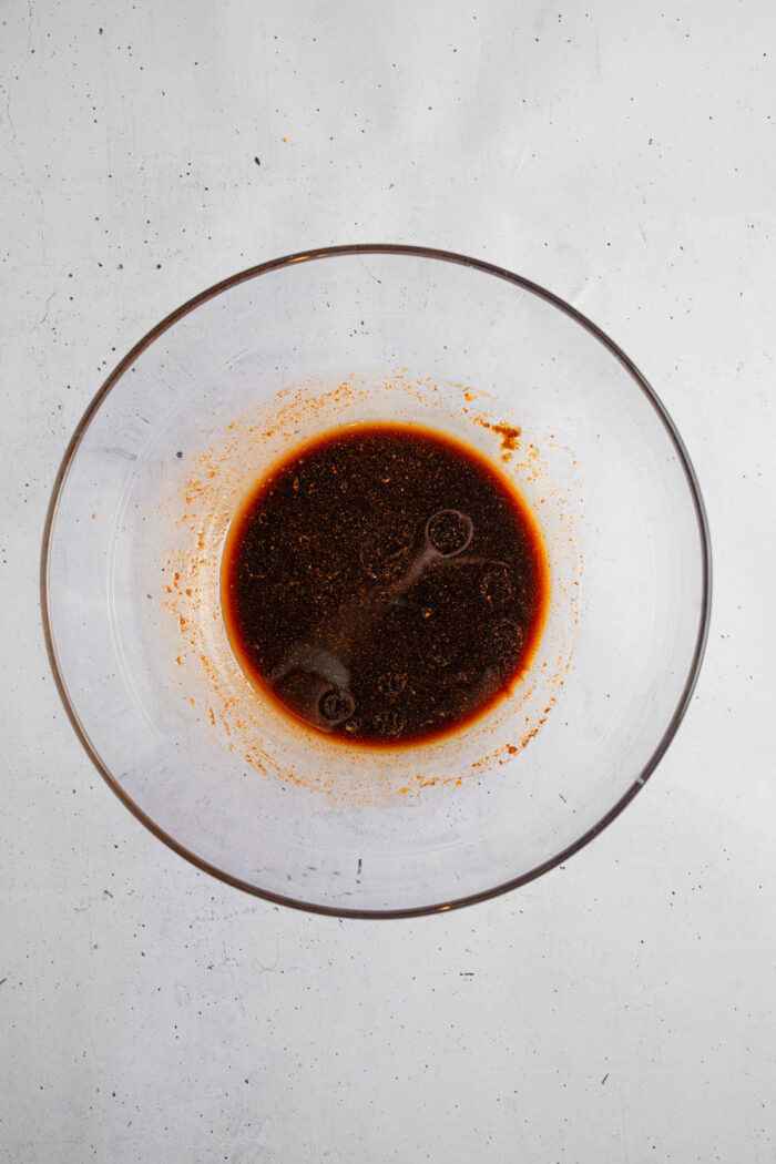 Tofu marinade consisting of soy sauce, maple syrup, olive oil, and other ingredients.