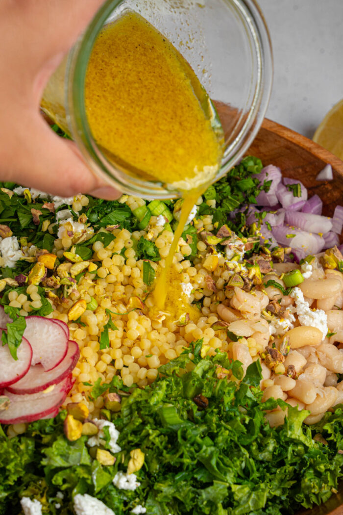 Chosen Foods Lemon Garlic Dressing poured over kale white bean salad.