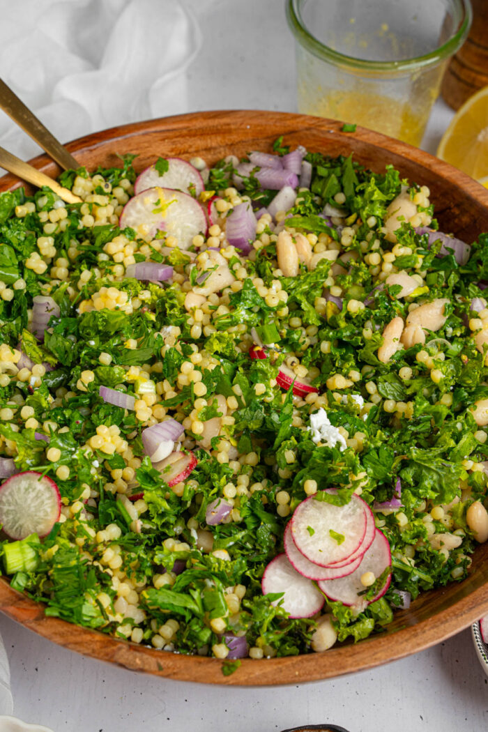 A large mixing bowl full of kale white bean salad.