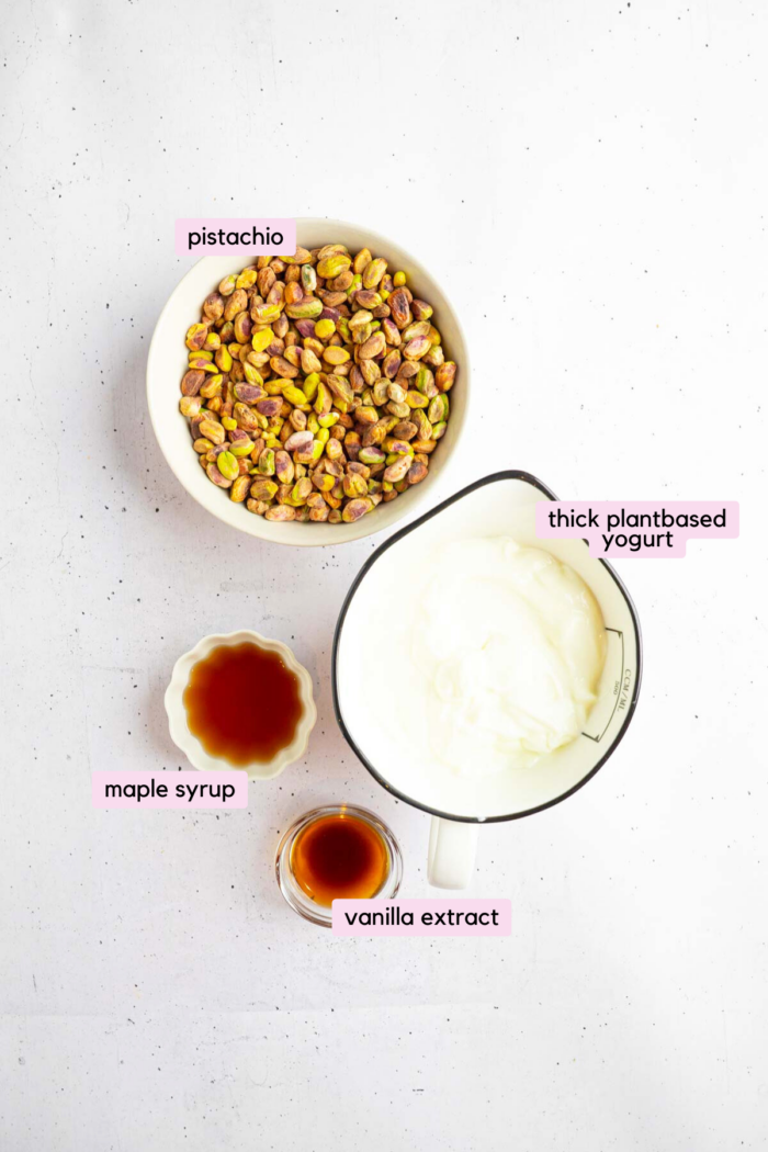 Ingredients for an easy vegan pistachio ice cream laid out and labeled on a plain light background.