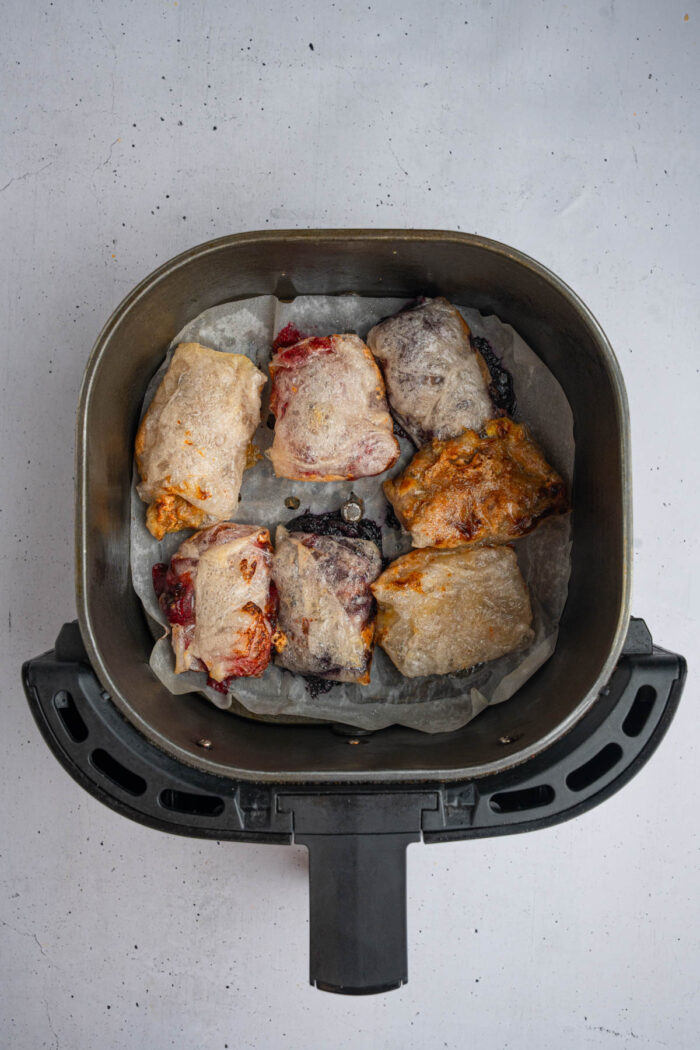 Crispy and crunchy air fryer sweet rice paper dumplings still in an air fryer drawer.