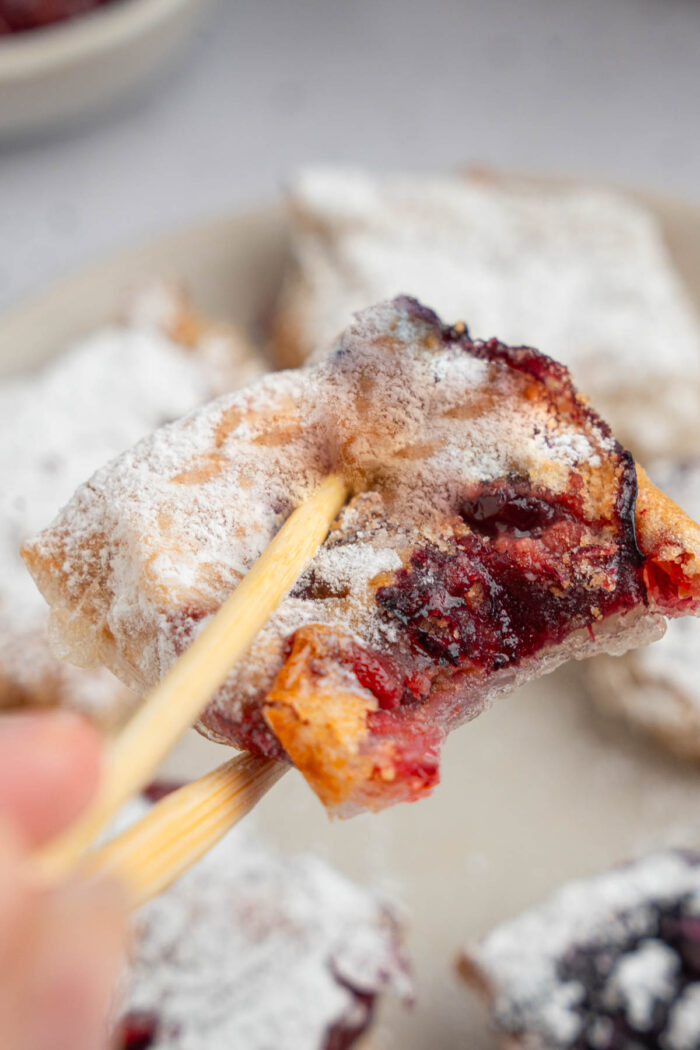 A close up photo of a sweet rice paper dumpling with a cross section visible.