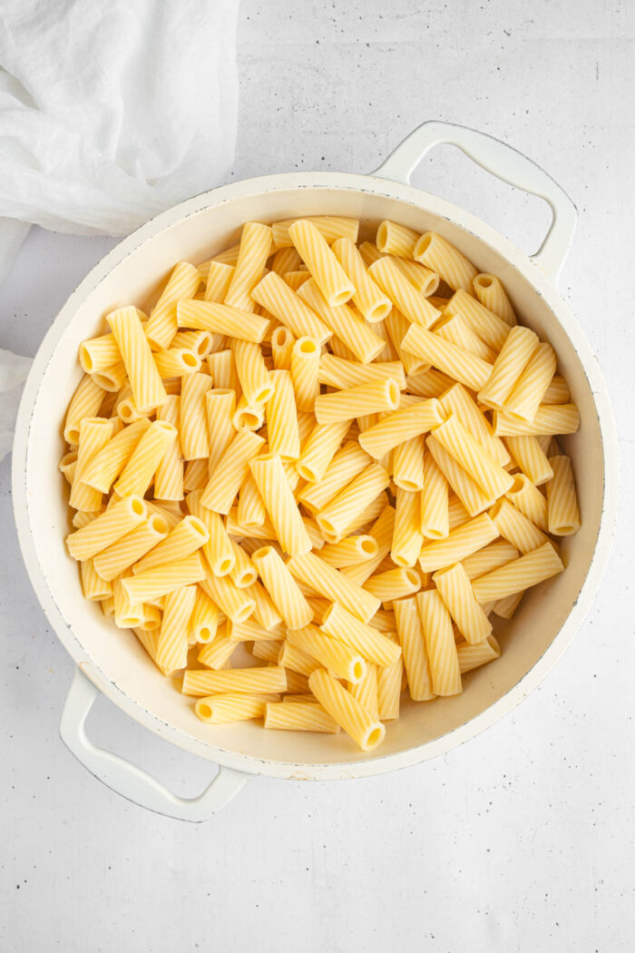 Cooked rigatoni pasta in a large white pot.