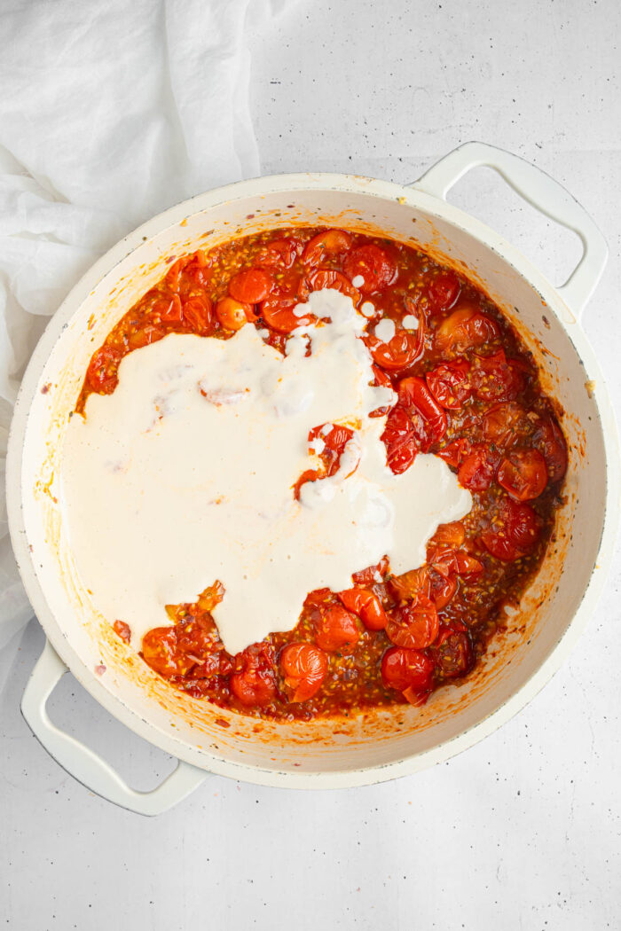 Cashew cream added to the tomato mixture to make creamy tomato pasta sauce.