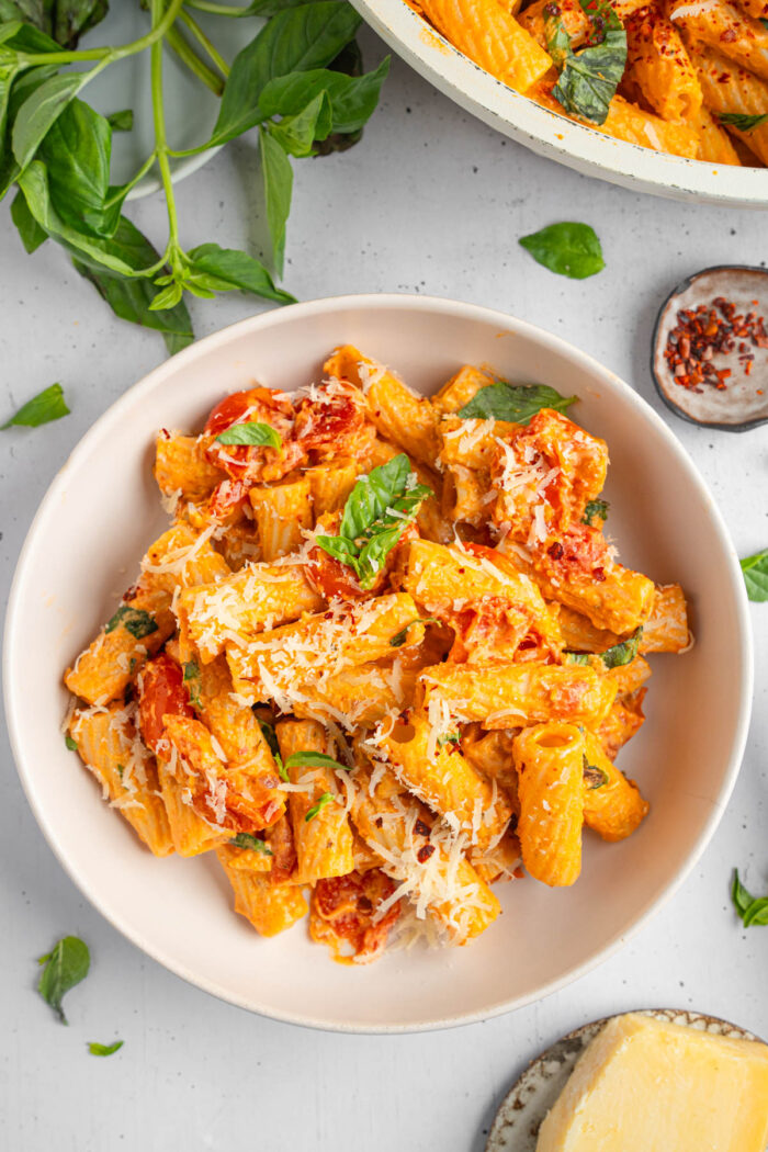 Creamy tomato pasta served in a shallow bowl.
