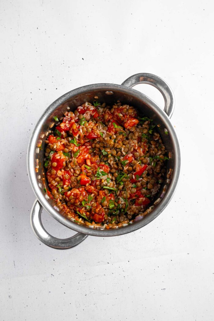 Cooked filling for the stuffed onions, including rice, lentils, and fresh tomato.