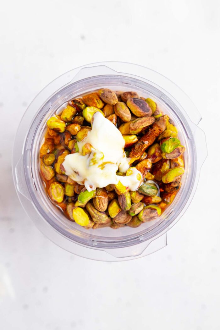 The ingredients for vegan pistachio ice cream added to a high-speed blender.