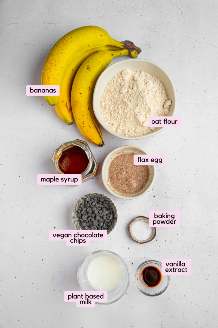 Ingredients for the vegan banana oatmeal muffins laid out and labeled on a light background.
