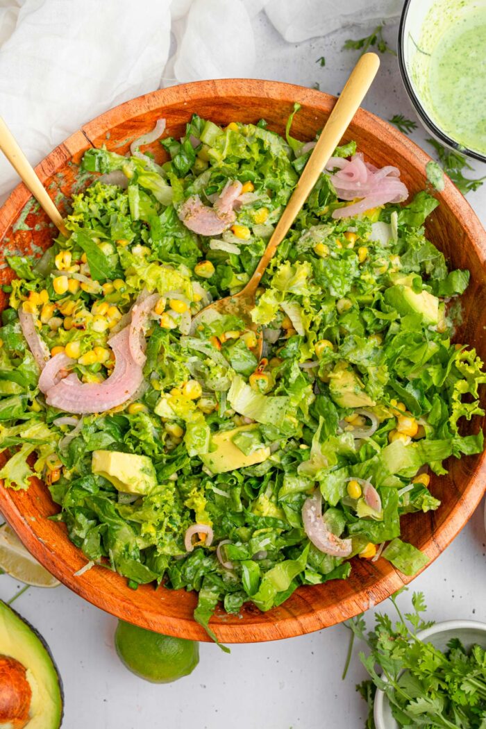 All of the ingredients mixed together to make avocado and corn salad.
