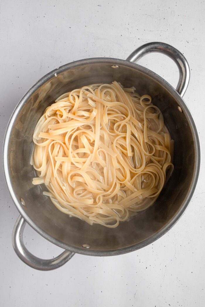 Fettuccine pasta cooked in the same water as corn cobs.