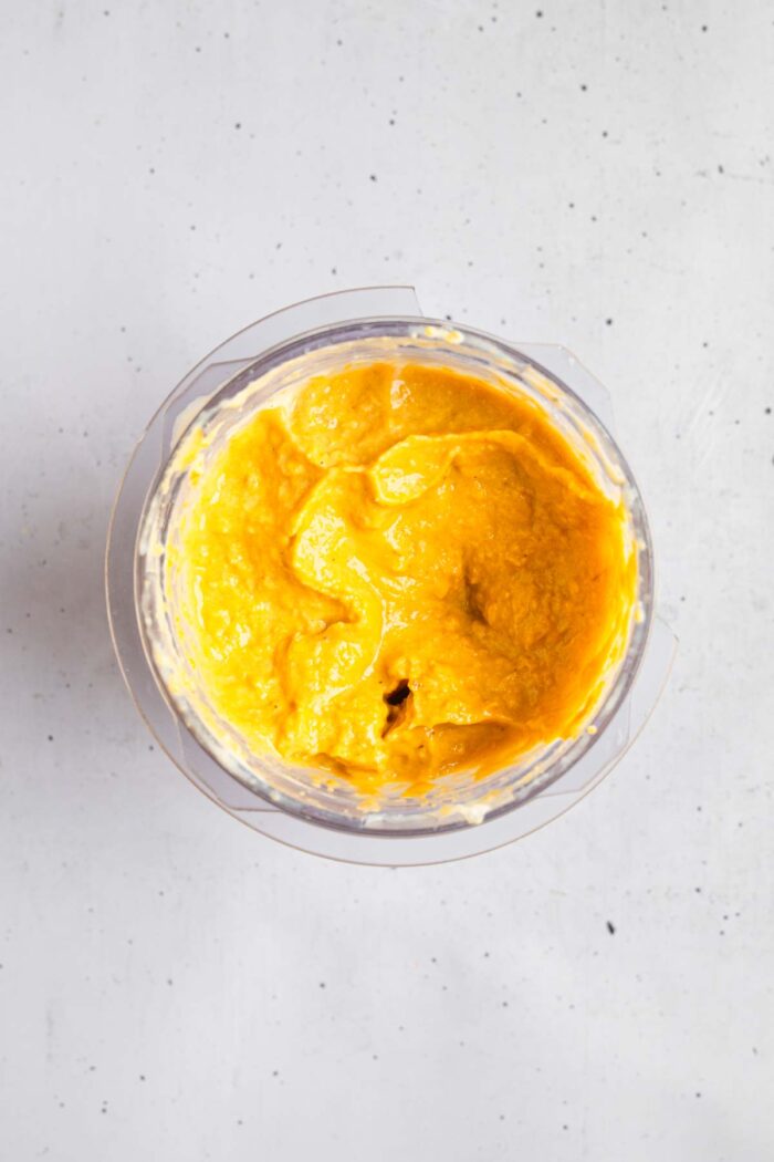 Corn blended into smooth, bright yellow mixture.