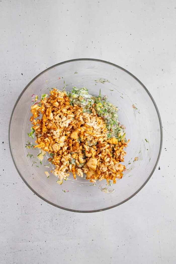 Shredded tofu added to the mixing bowl with the rest of the ingredients.