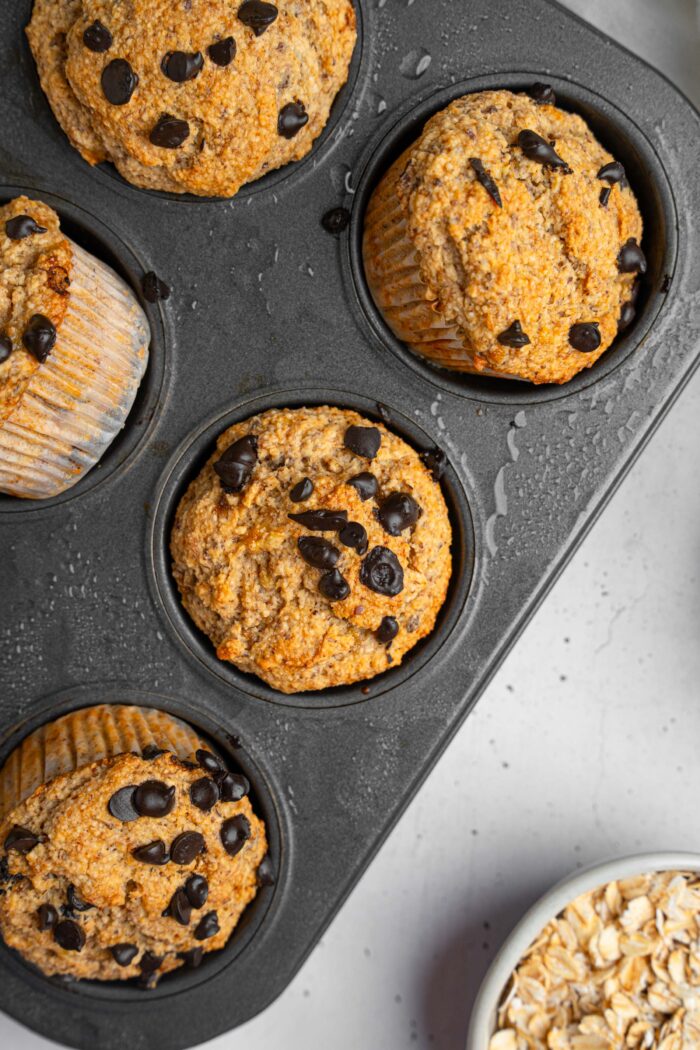 A close up view of a banana oatmeal muffin, still in a muffin tray.