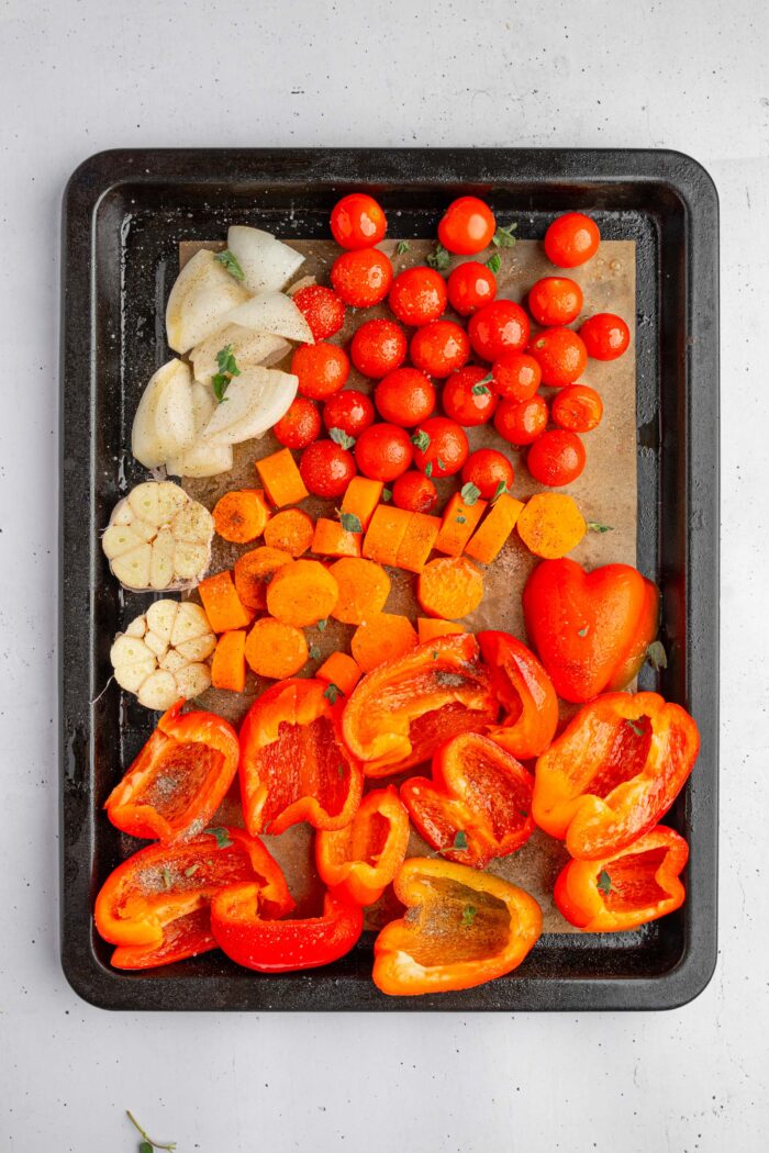 Vegetabled laid out on a lined sheet pan.