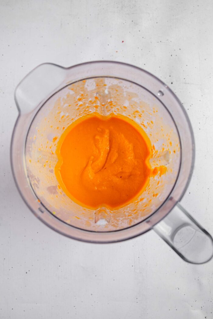 Roasted red pepper carrot soup blended until smooth, still in a high-speed blender.