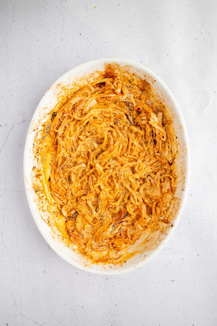 After cooking, the caramelized onions are browned in the casserole dish.