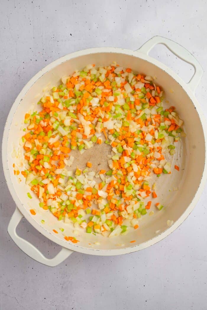 Carrot, celery and onions being sauted in a ceramic non-stick pan.
