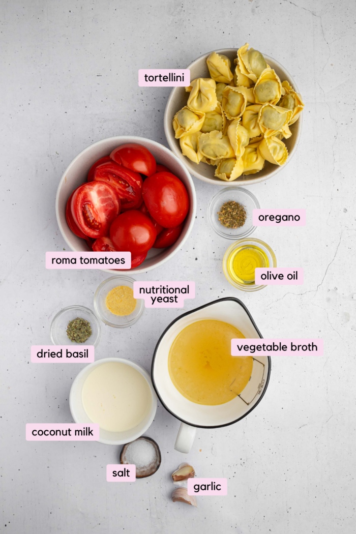 Ingredients to make creamy tortellini pasta, laid out and clearly labeled on a white background.