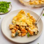 Tuscan chickpea pot pie served on a ceramic plate woth a fork picking up a piece.