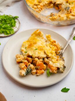 Tuscan chickpea pot pie served on a ceramic plate woth a fork picking up a piece.