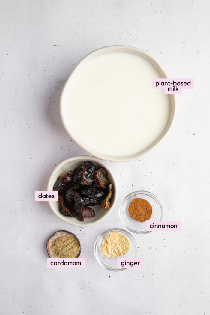 Ingredients for the warm date milk, including vegan milk, dates, and spices.