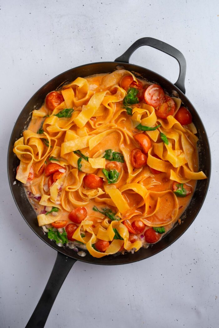 After heating up, the pasta softens and the spinach wilts a little.