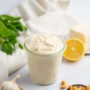 Tofu cream transferred into a clear jar, with the ingredients visible in the background.