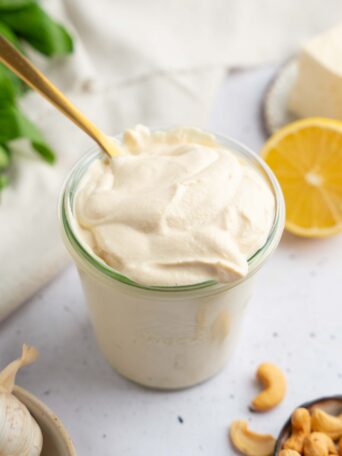 Tofu cream in a glass jar, with a golden spoon sticking out.