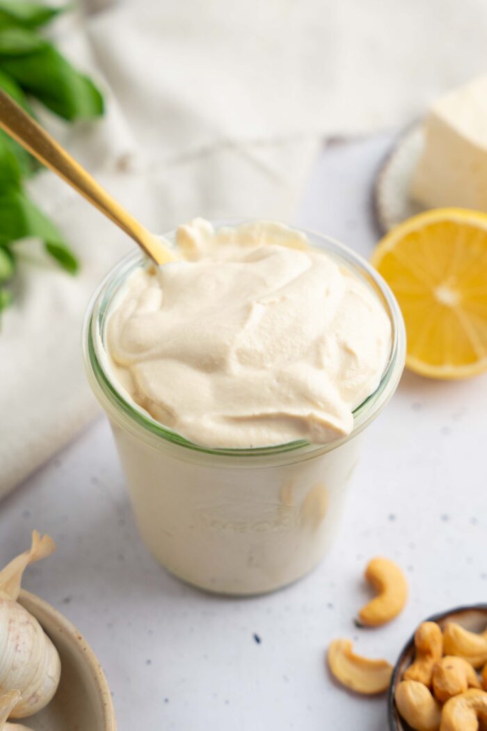 Tofu cream in a glass jar, with a golden spoon sticking out.