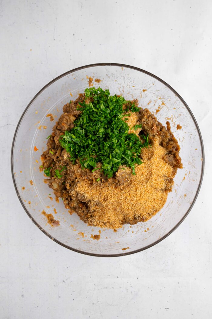 Breadcrumbs, chopped parsley, and seasonings added to the lentil mixture.