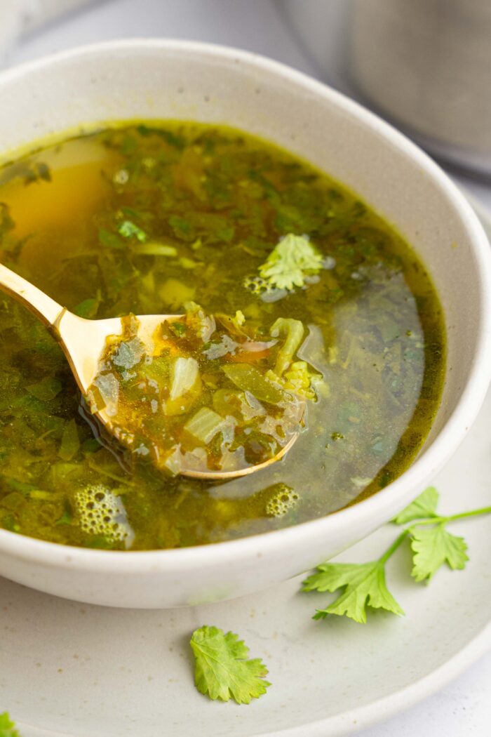 A closer shot of a spoonful of cilantro lemon soup.