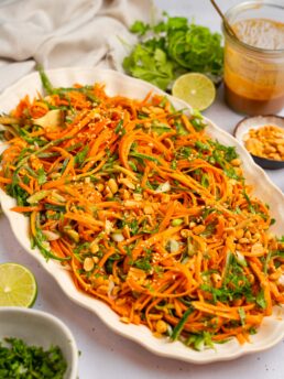 Carrot and cucumber salad served in a large oval serving dish.