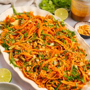Carrot and cucumber salad served in a large oval serving dish.