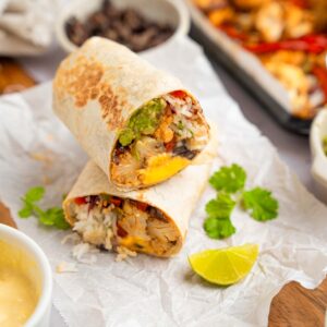 One of cauliflower burritos served after air frying, cut in half and showing off the cross section.