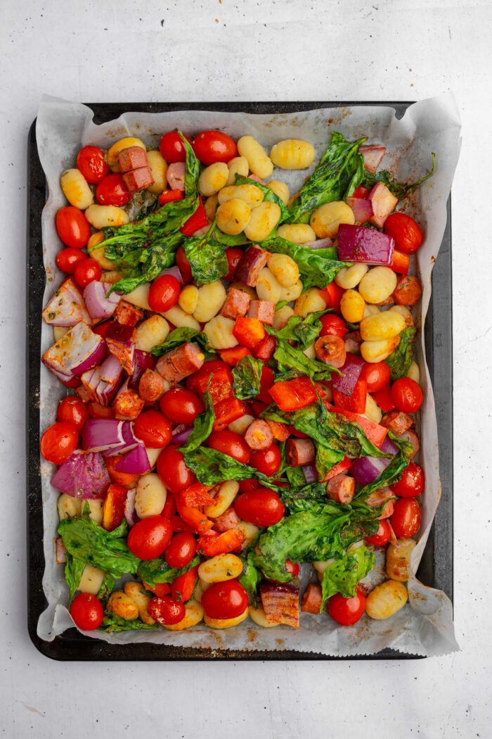 Vegan sheet pan gnocchi with sausage and pesto fresh out of the oven.
