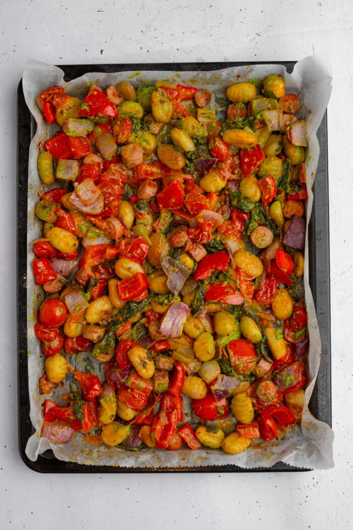 A delicious baking tray of vegetable and vegan sausage gnocchi dish.
