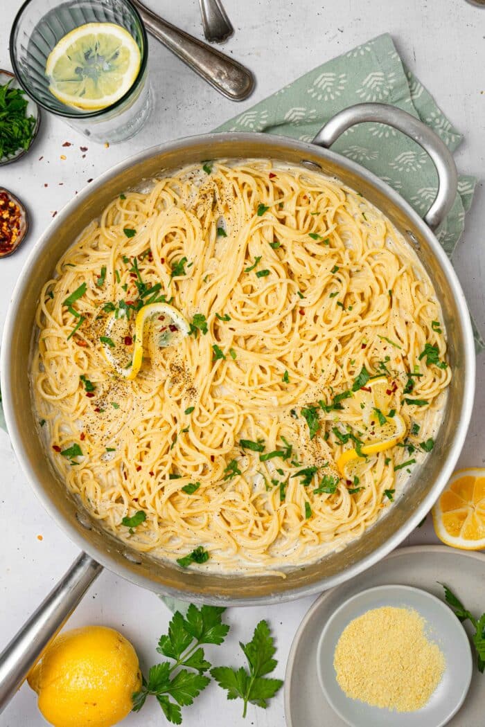 Easy vegan alfredo pasta finished with lemon juice and fresh herbs.