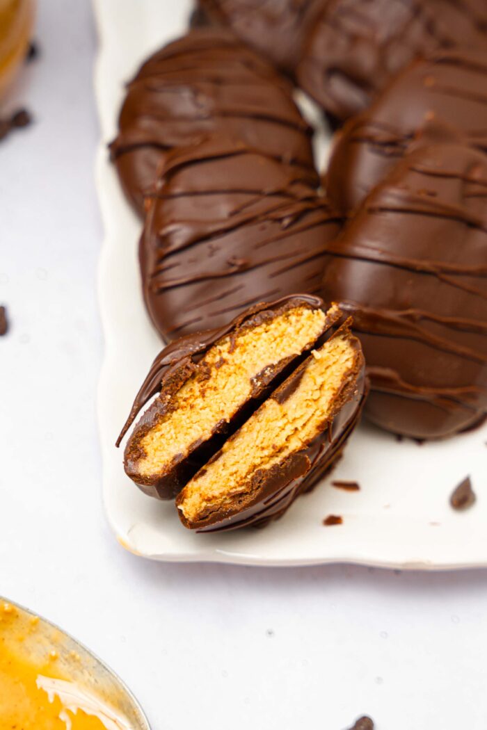 One of chocolate peanut butter Easter eggs broken in the middle to show the filling.