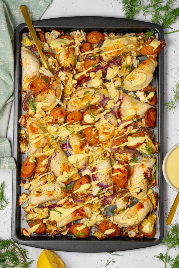 Sheet pan pierogies with cashew cheese sauce drizzled on top.