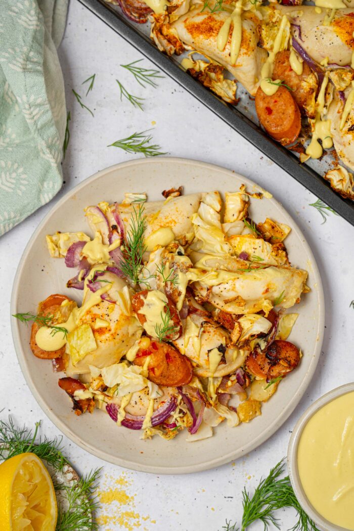 A serving of sheet pan pierogies with cashew cheese sauce, served on a white plate.