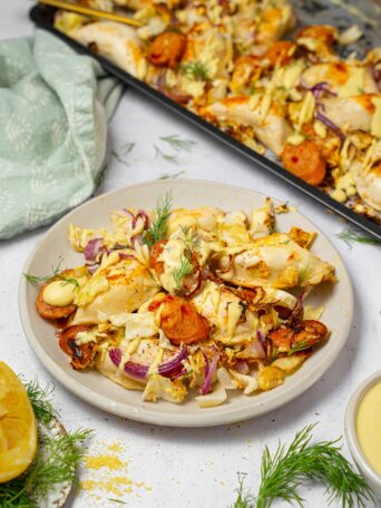 A serving of sheet pan pierogies with the rest of the dish visible in the background.