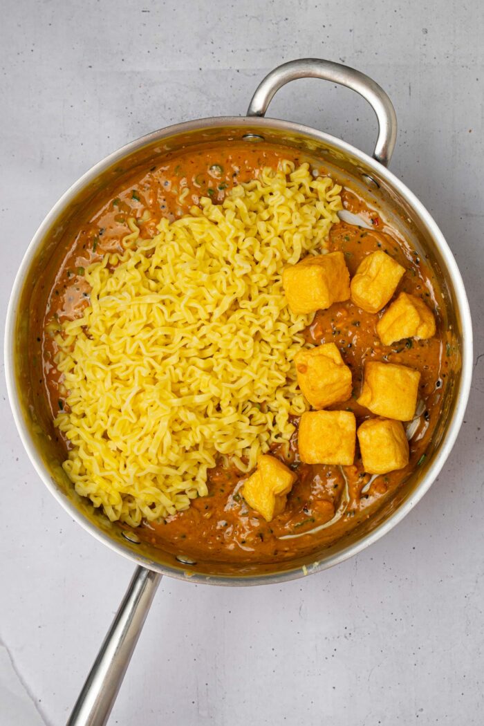 Cooked ramen and puffed tofu added to the chili peanut sauce.