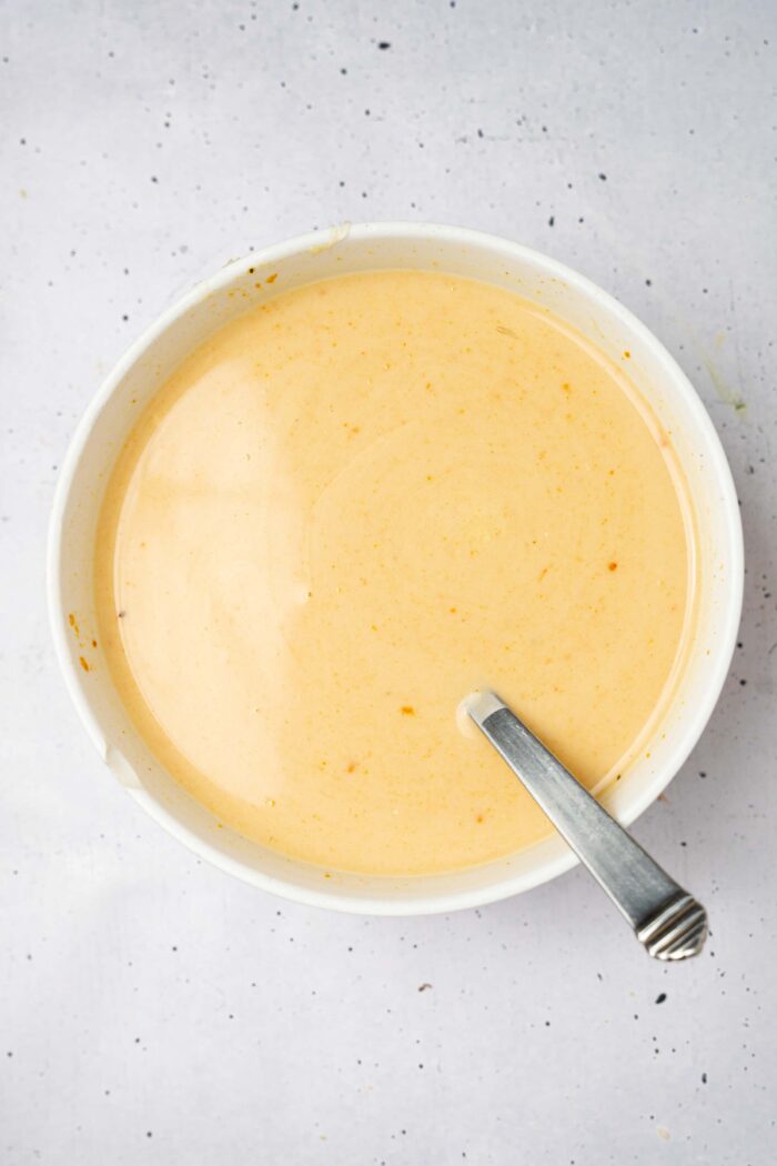 The sauce which will cook the noodles and steam the dumplings, mixed up in the bowl.