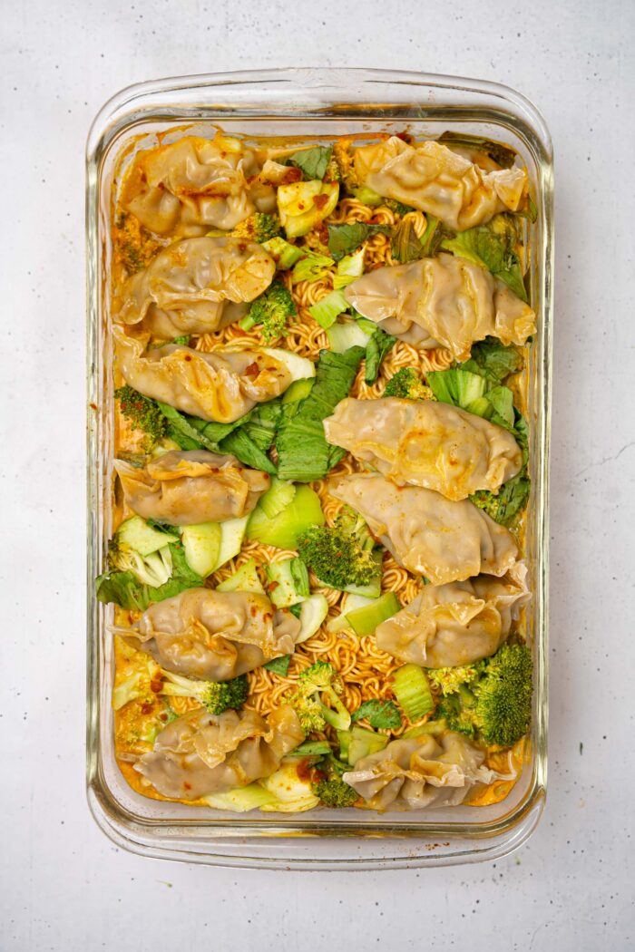 After cooking in the oven covered, the dumplings and ramen are cooked and the bok choy is tender.