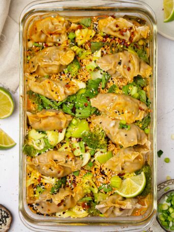 Dumpling bake, still in the baking dish, served with sesame seeds and chili flakes.