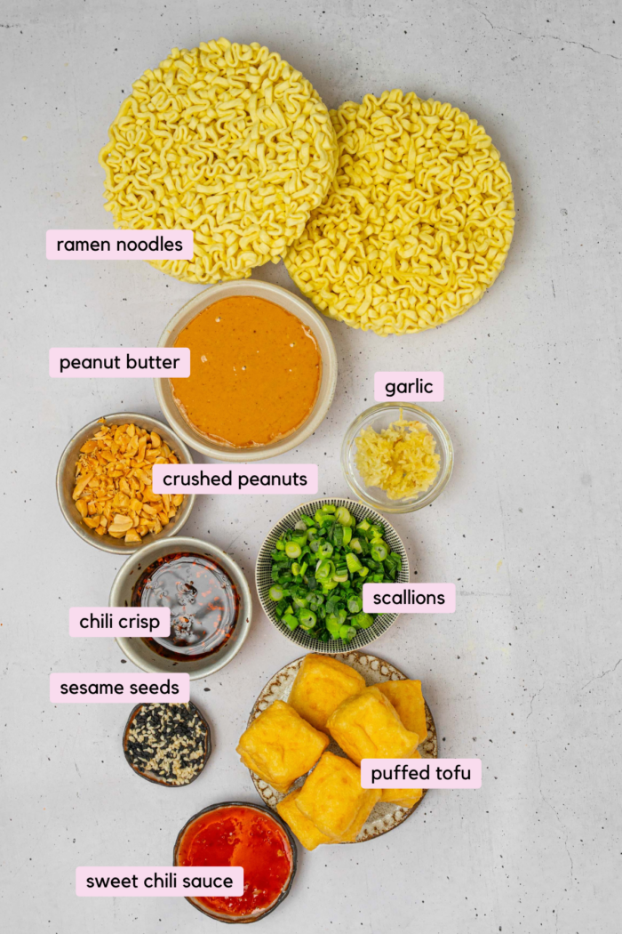 The ingredients for chili oil peanut noodles laid out and labeled on a clear background.