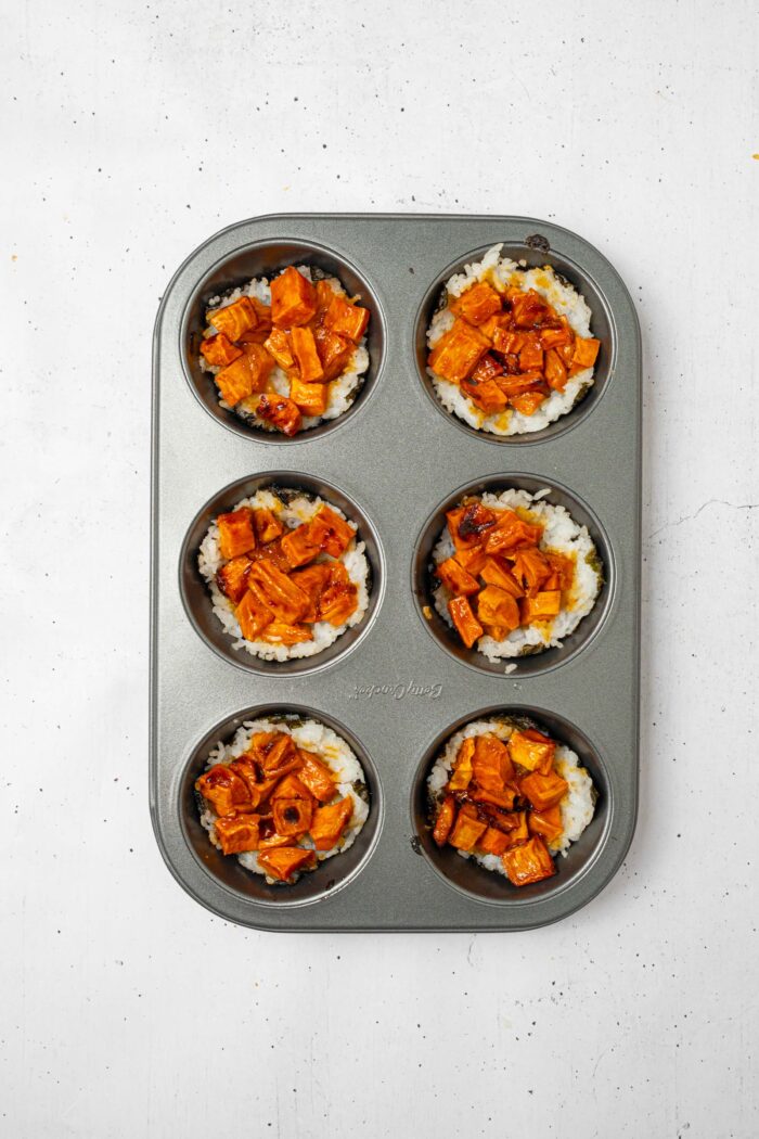 The muffin tray with the sushi cups, now filled with sweet potato mixture.