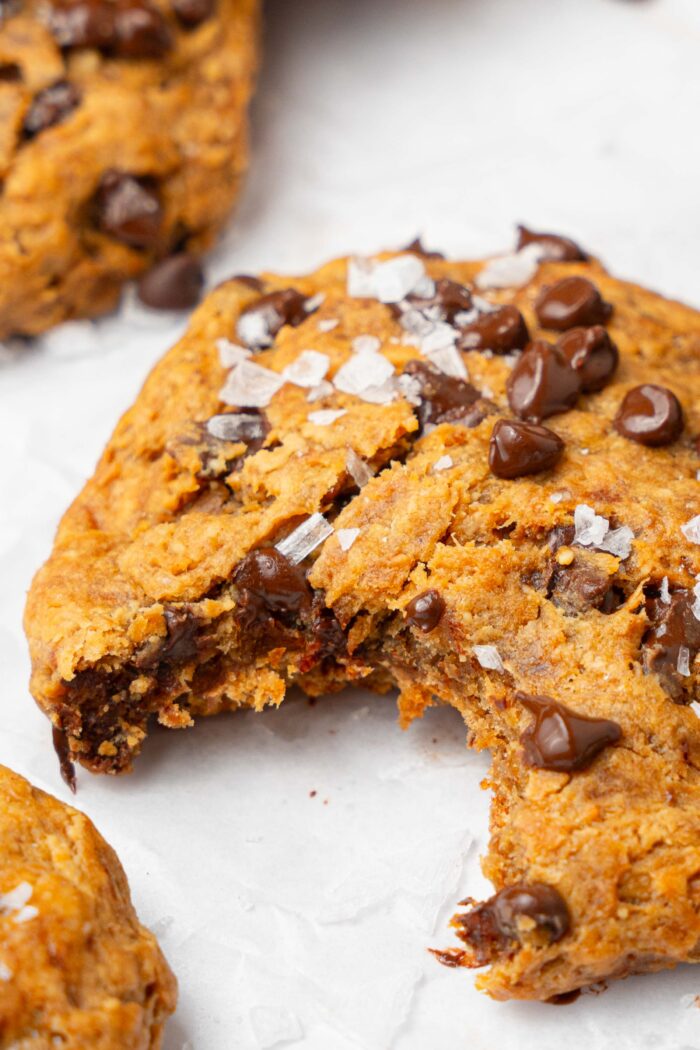 A vegan protein cookie with a big bite taken out.